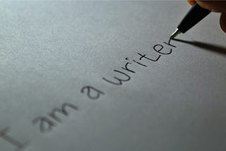 A pen writing “I am a writer”
