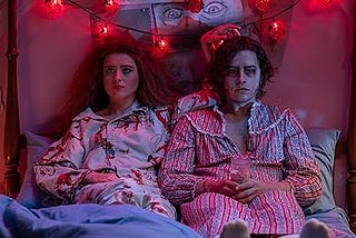 Actress Kathryn Newton and actor Cole Sprouse in 80’s era pajamas in a scene from the movie Lisa Frankenstein.