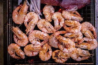 The Right Way My mom and I eat shrimp with piles of shells stacked between us