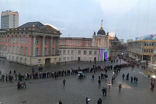 Line of people outside an old building