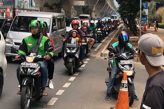 What business are companies like GRAB and GOJEK in?