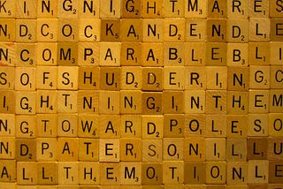 picture of Scrabble tiles next to one another with some words spelled including comparable, shuddering and toward