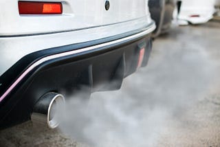 A car releasing carbon emissions into the environment as it looks for parking endlessly