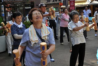 Senior Japanese people training outside.