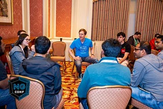 A group of people sitting in a circle having a discussion