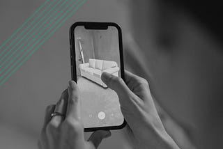 Black and white image of a person holding a smart phone using an AR application to visualize a new sofa in their home. Over the image are green diagonal lines. In the bottom right is the Kontor logo.