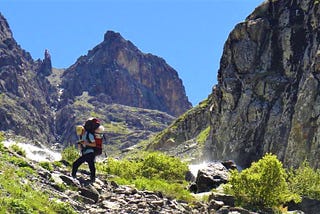 The boy was reading a dictionary all the way in the stunning mountain Path