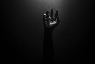 dark background with a fist raised