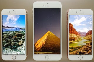 Three iPhones Laying on a Table