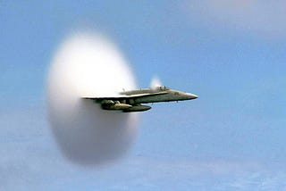 A picture of an aircraft breaking the sound barrier