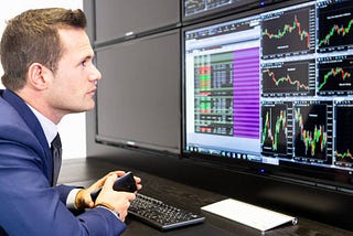 man focused on monitoring his trades