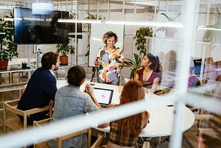 Five people meeting around a conference table