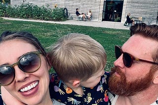 author with her partner and son, hugging