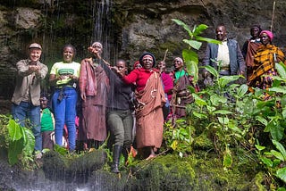 An expression of joy upon visiting a sacred cave along the slopes of Mount Elgon.