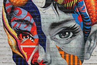 Street art mural of Audrey Hepburn: a black and white illustration with patterns of abstract color.