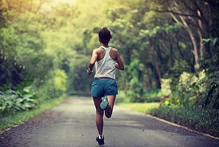 Female runner running at summer park trail to improve stamina