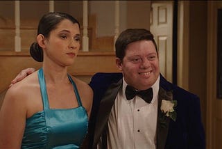 Still from “At Last” — Lauren poses for a prom photo for her mom at home with her date, Flash