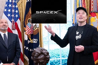 Elon Musk holding up the SpaceX logo