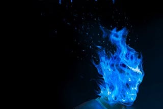 Man in a vest with blue flame completely engulfing his head. The words Psychodrama are stylized above it.