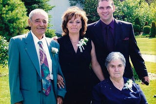 Your author stands with his wife and her parents, dressed up for a wedding