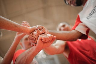 People holding hands to show motivation