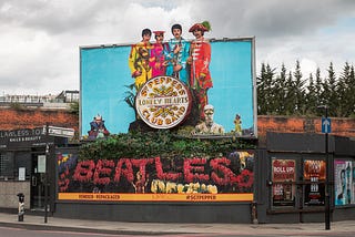 Photo of a billboard displaying the Sgt. Pepper’s album cover in celebration of Sgt. Pepper’s 50th Anniversary,