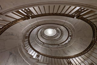 View from below of a tightly circling spiral staircase