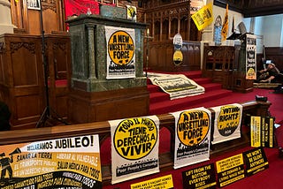 A scene (signs displayed at the front of the church sanctuary at Grace UMC) from the March 2 Poor People’s Campaign rally in Harrisburg, where hundreds of people from across the street impractically gave up their Saturday to stand up for the rights of those from the margins