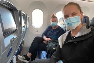 Lauren and her wife, seated on the airplane en route to Germany