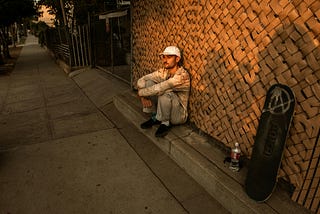 homeless man sitting in alley