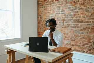 A guy working on his laptop.