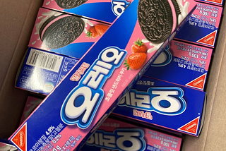 Several rectangular boxes of strawberry oreos with Korean text.