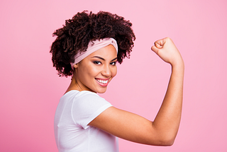 A back woman striking a powerful and confident pose