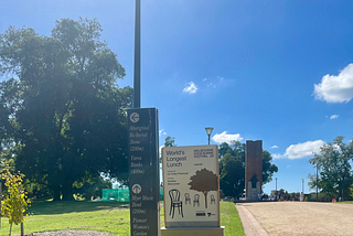 Park and event signage positioned next to one another at King’s Domain.