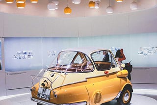 photo of a car in a museum setting. Photo by Nastya Dulhiier, Unsplash