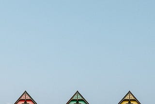 A simple picture of three cropped rooftops next to each other, very close together. Like painted ladies in San Francisco.