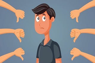 A man feeling sad at receiving several thumbs down as a sign of rejection