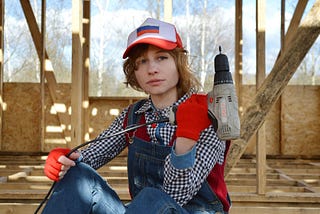Young woman holding a drill