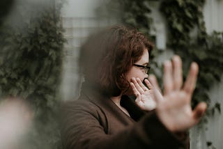 Woman putting up her hands in a gesture of refusal