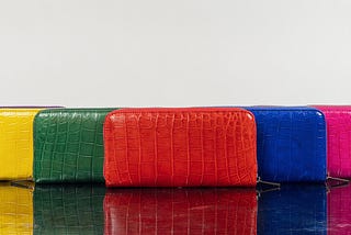 Group of genuine crocodile skin wallets for women with different colors from Sherrill Bros