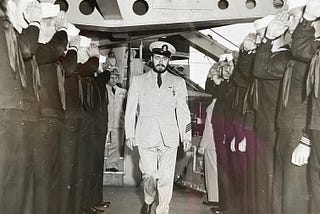 Naval officer being saluted by sailors