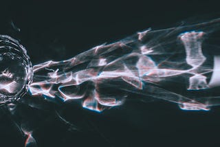 Abstract glass reflections on a dark surface, symbolizing the Liquid Glass transition effect in iOS 26.