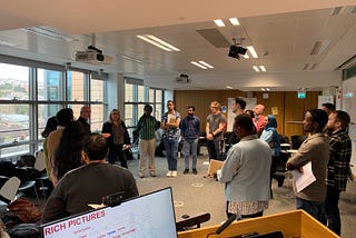 Group of 15 people standing in a circle