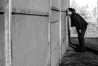 Berlin war memorial monochrome photo with man looking at wall