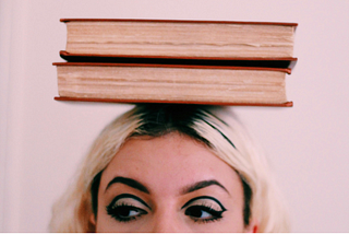 Photo by Mahrael Boutros: https://www.pexels.com/photo/two-book-on-woman-head-1215714/