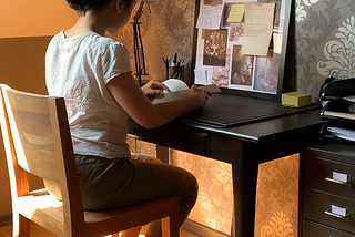 the author reading a book at her desk