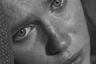 Screen shot from Ingmar Bergman’s film The Passion of Anna. Black and white close up of a woman’s face. She seems to be in despair. The subtitle says: I didn’t think that life would amount to such daily suffering.