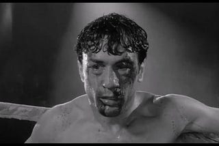 Jake DeMotta beaten bloody and barely holding it together on the ring from the movie Raging Bull