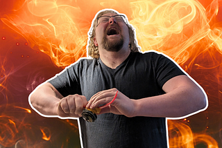 Image of the author holding a launcher that is primed with a top. He has his eyes closed and head tilted back in a scream as he prepares to launch it. In the background, flames surge.