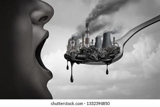 Image of a person eating a spoon full of polluting factories